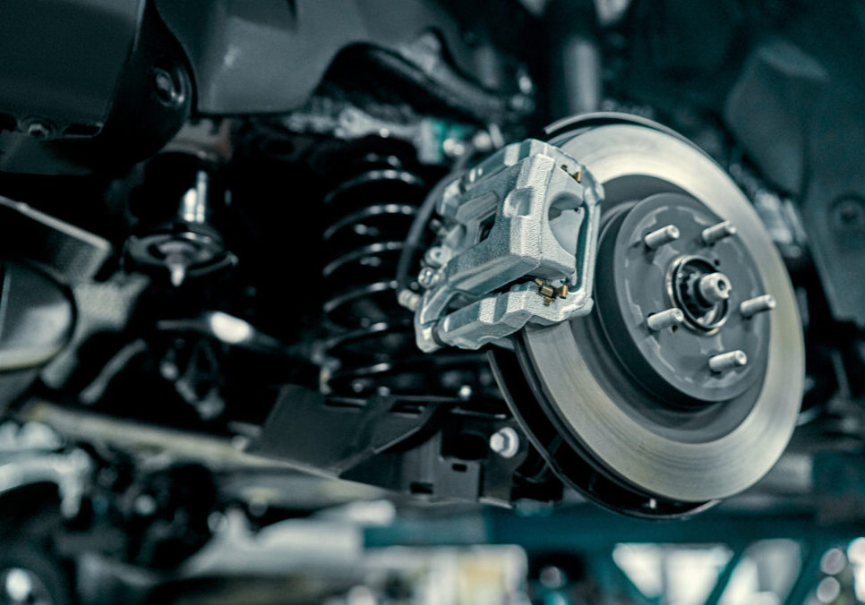 brakes Disc brake of the vehicle for repair, in process of new tire replacement. Car brake repairing in garage.Suspension of car for maintenance brakes and shock absorber systems.Close up.