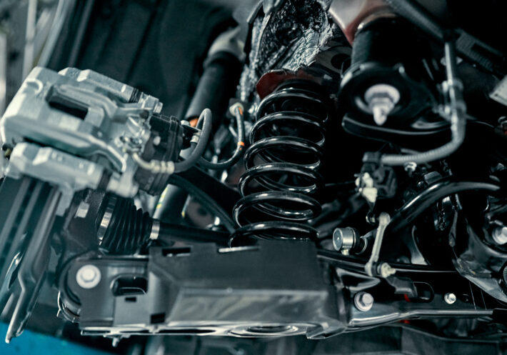 car-suspension Rear suspension of a modern car. Elements and design of the rear suspension. Rear suspension beam, spring, shock absorber.